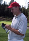 IntelliGolfer Joe Buchberger enters his score on his handheld device.